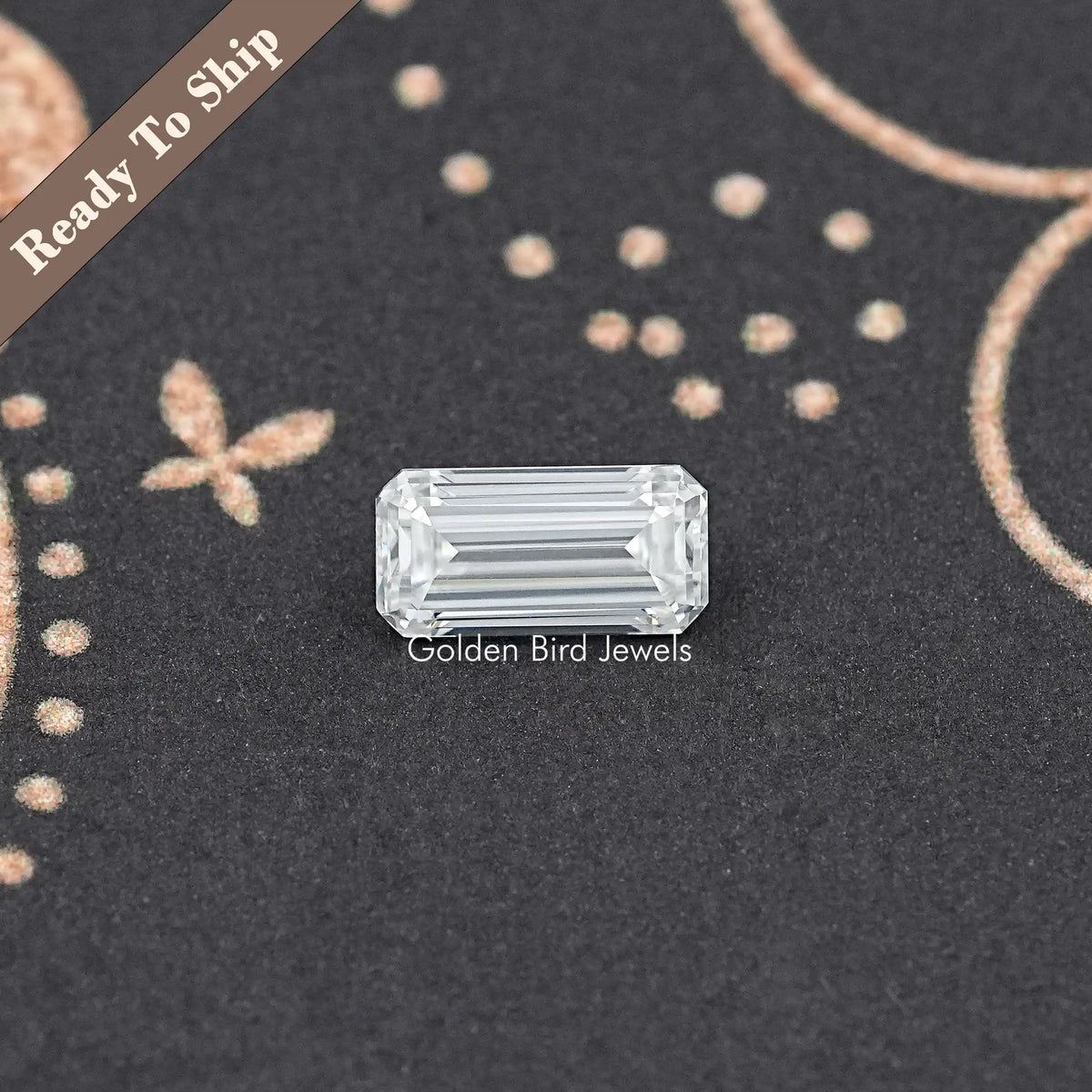 Loose emerald-cut moissanite gemstone, clear rectangle with faceted edges.