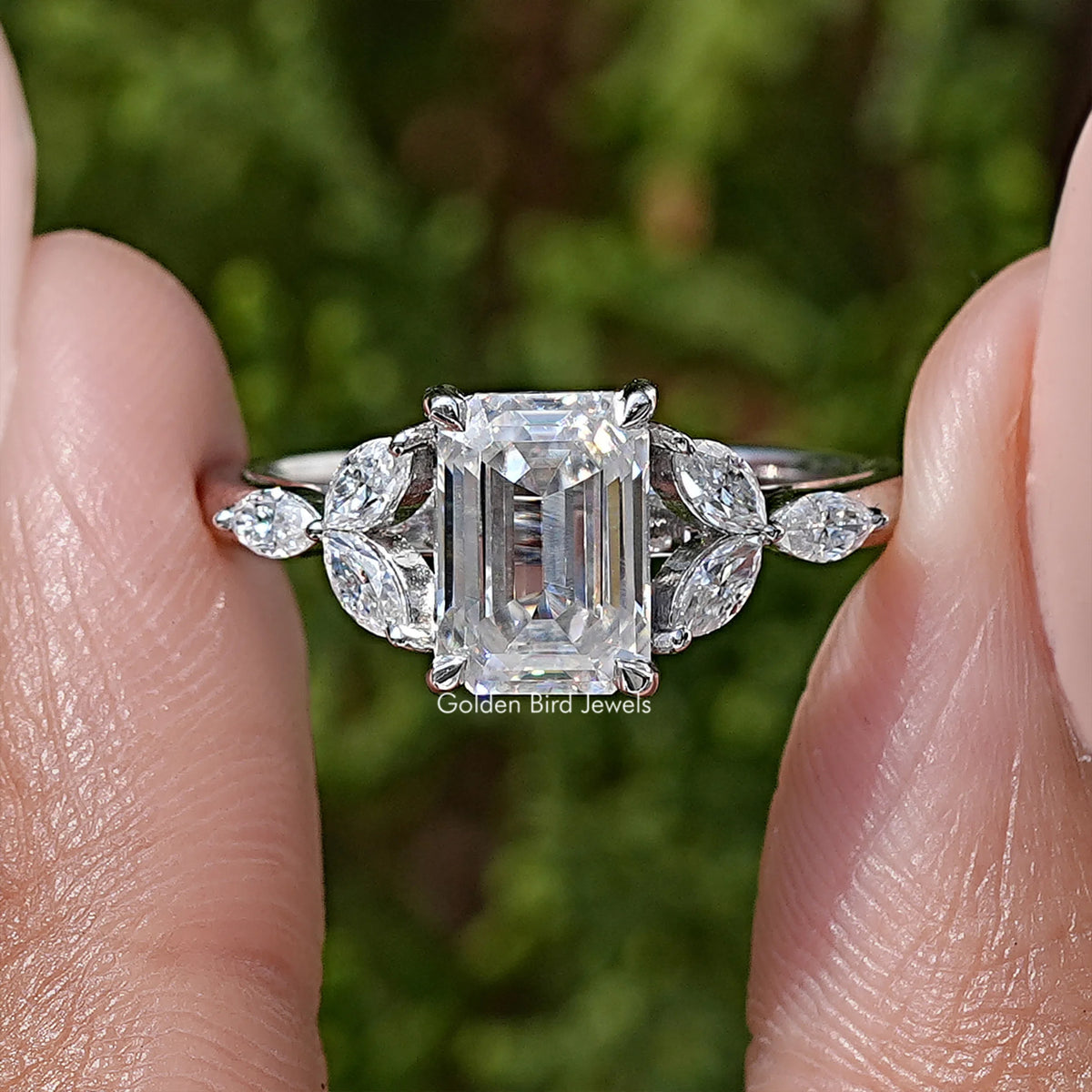 925 silver moissanite ring close-up: emerald-cut center with marquise side stones