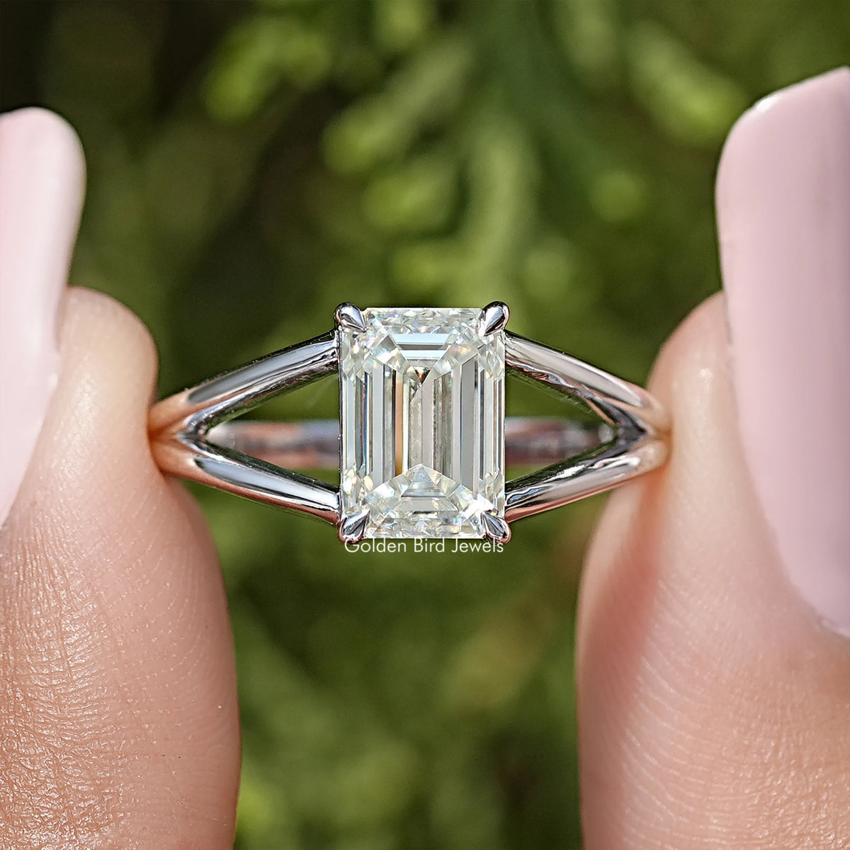 Sterling silver split-shank ring with emerald-cut center stone, angled close-up