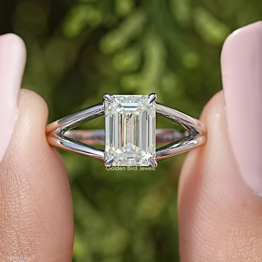 Sterling silver split-shank ring with emerald-cut center stone, angled close-up