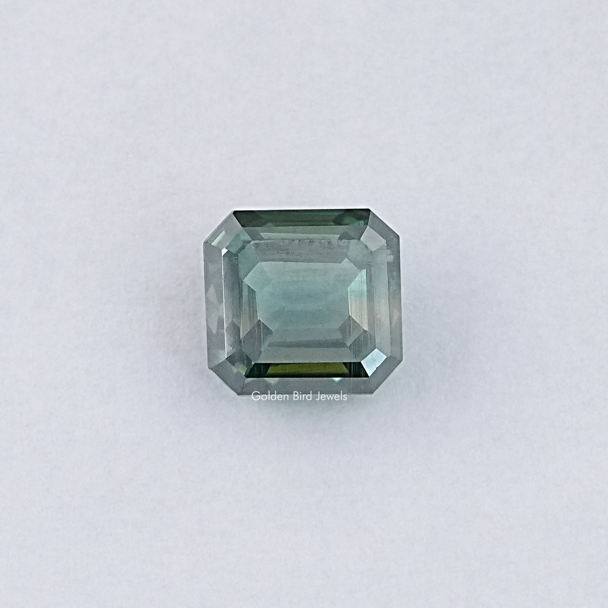 Green emerald-cut loose moissanite gemstone, light green step-cut facets