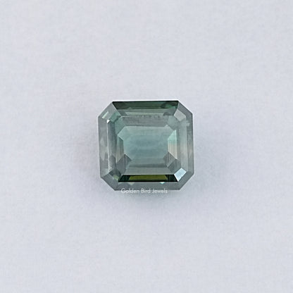 Green emerald-cut loose moissanite gemstone, light green step-cut facets