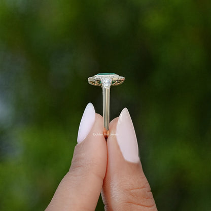 Silver ring with emerald-green gemstone bezel and prong setting, side profile