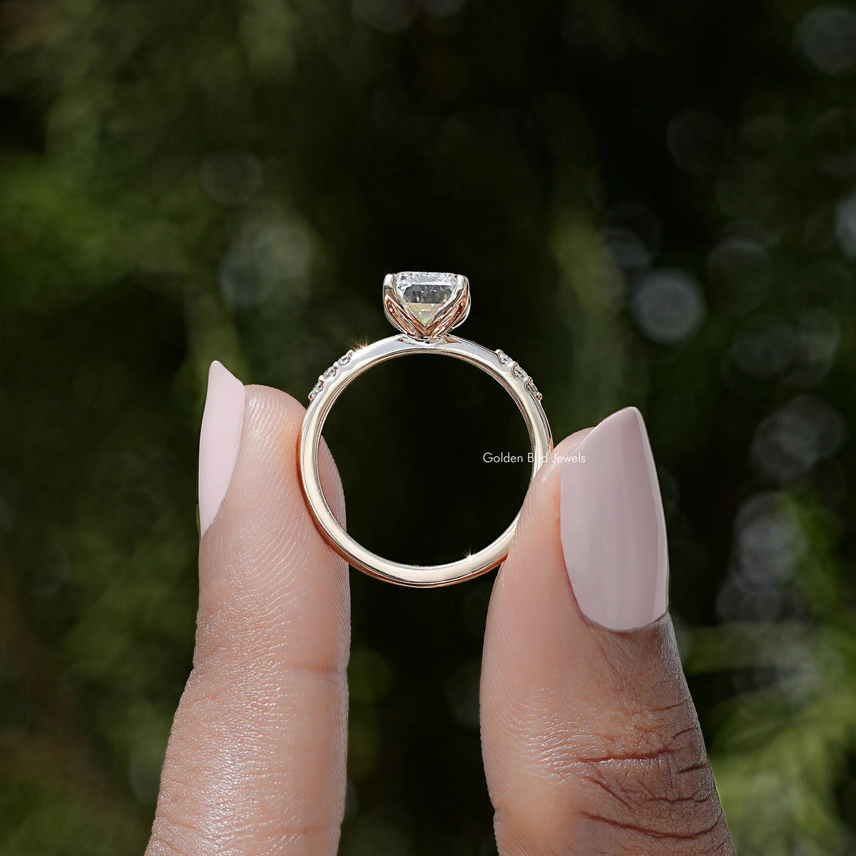 Emerald-cut lab diamond ring with curved open band and prong-set center stone