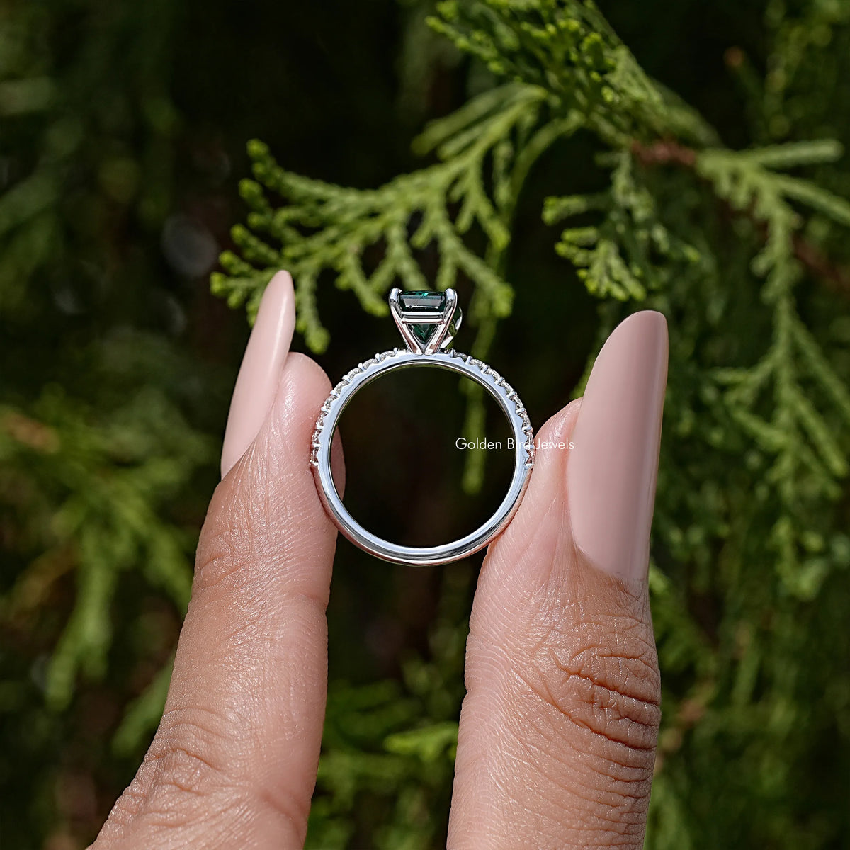 Sterling silver solitaire ring with green moissanite center and split prong setting