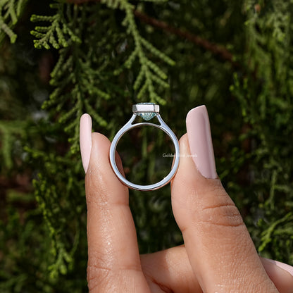 Sterling silver ring featuring an emerald-cut blue stone in a bezel setting