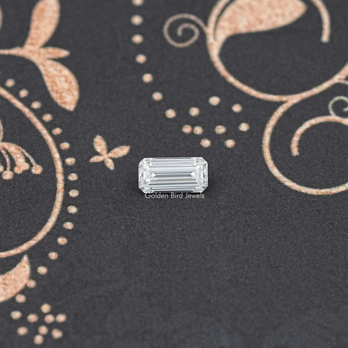 Loose emerald-cut moissanite gemstone, clear rectangular step-cut stone.