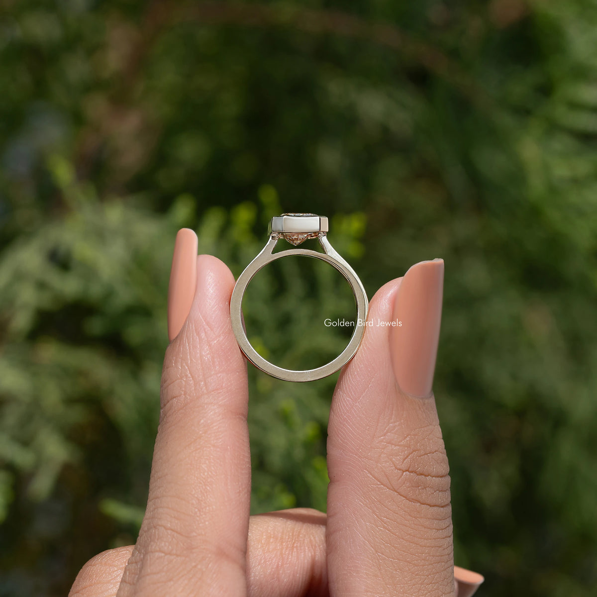 Rose-gold solitaire ring with emerald-cut moissanite center stone on open band