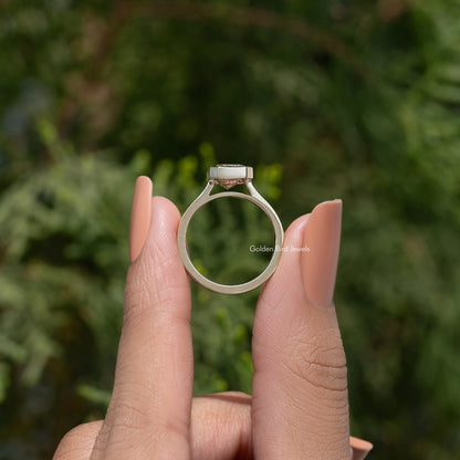 Rose-gold solitaire ring with emerald-cut moissanite center stone on open band