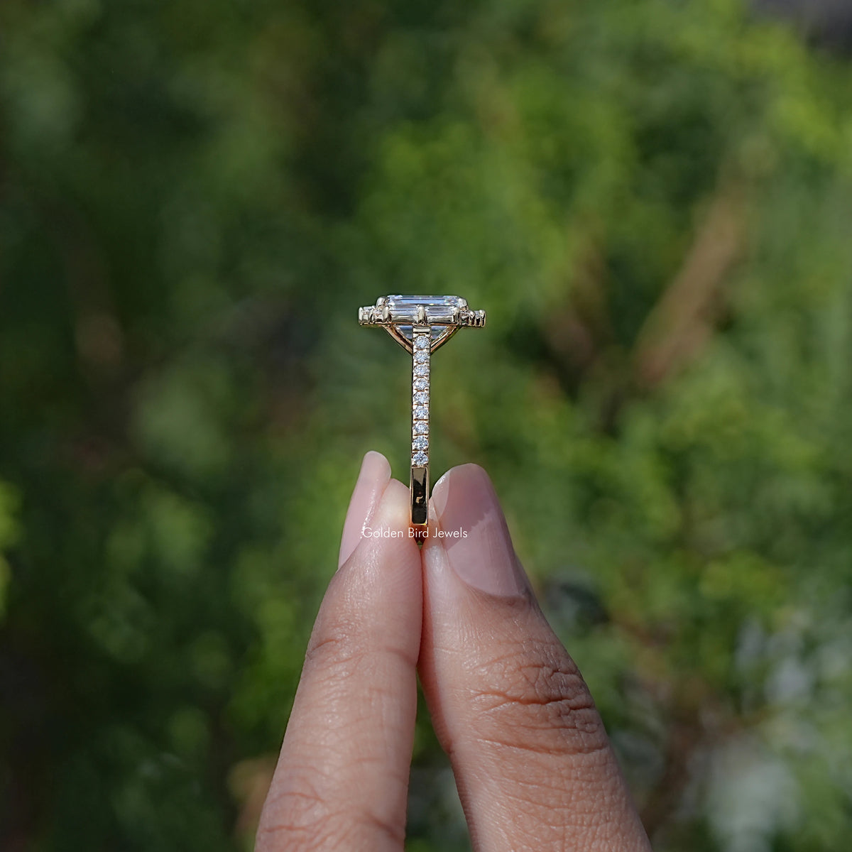 Emerald-cut halo moissanite engagement ring on prongs with split baguette band