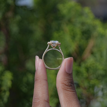 Emerald-cut halo moissanite engagement ring with baguette detail, side profile