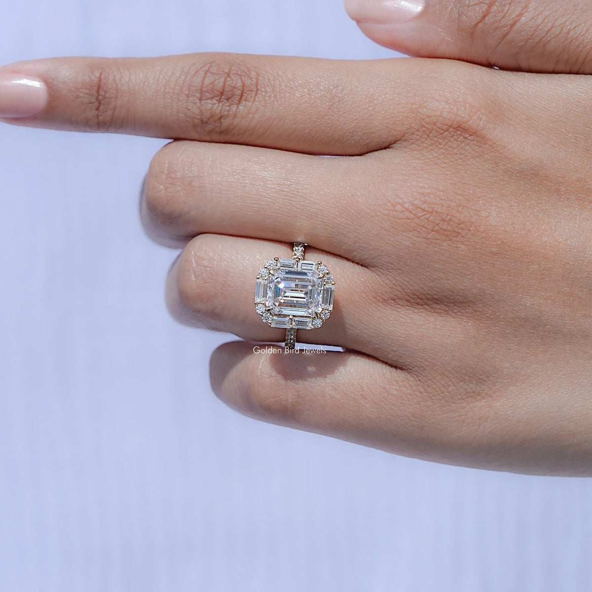 Emerald-cut halo moissanite engagement ring with square centerpiece and prong setting