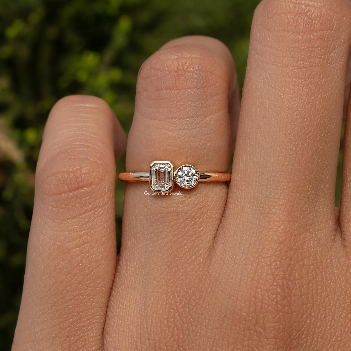 Gold-tone toi et moi ring with round and emerald-cut lab diamonds on a slim band