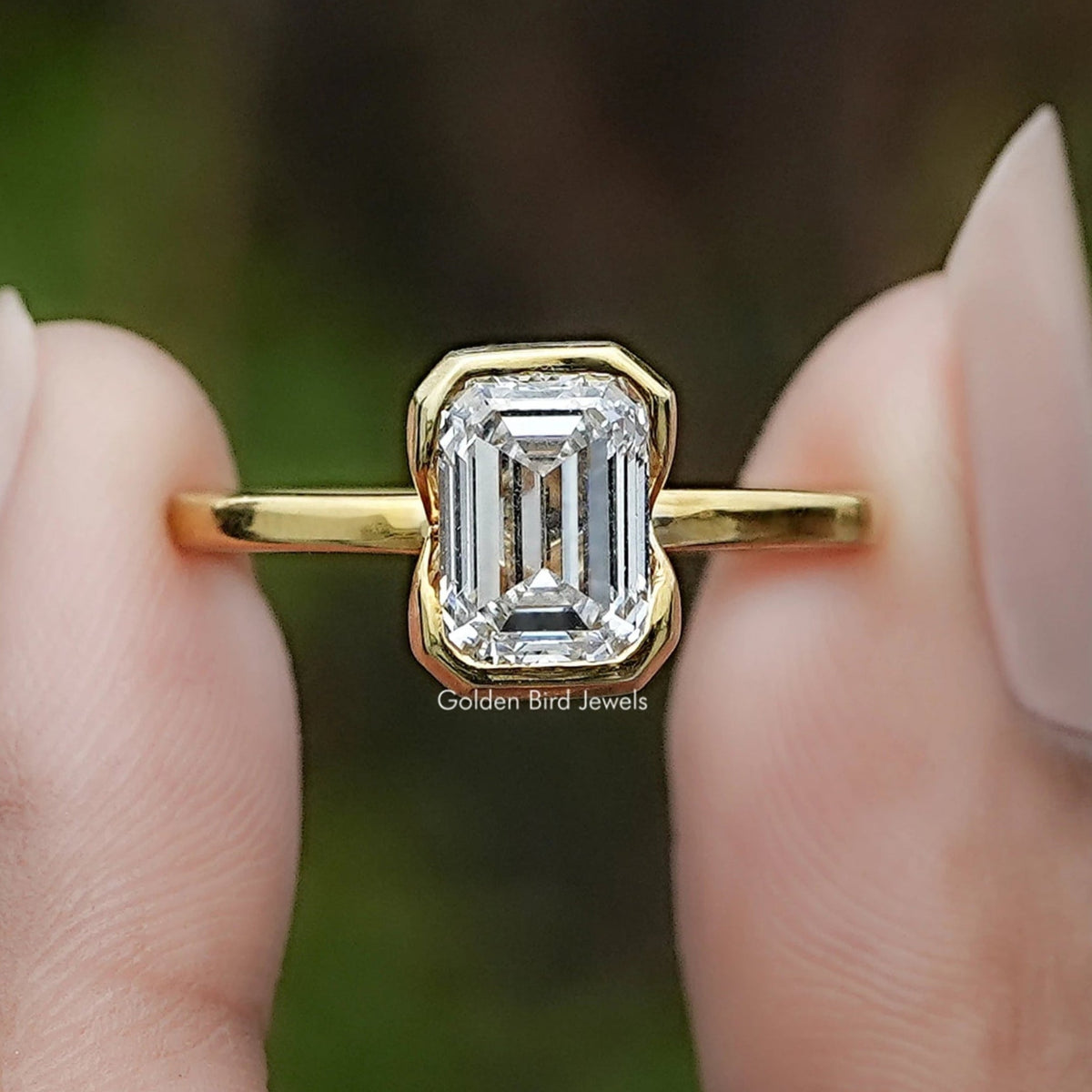 Emerald Cut Lab Diamond Bezel Set Solitaire Ring In Two Fingers