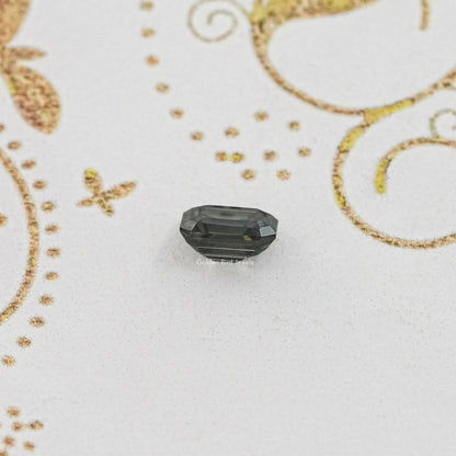 Loose dark gray emerald-cut moissanite gemstone, step-cut facets