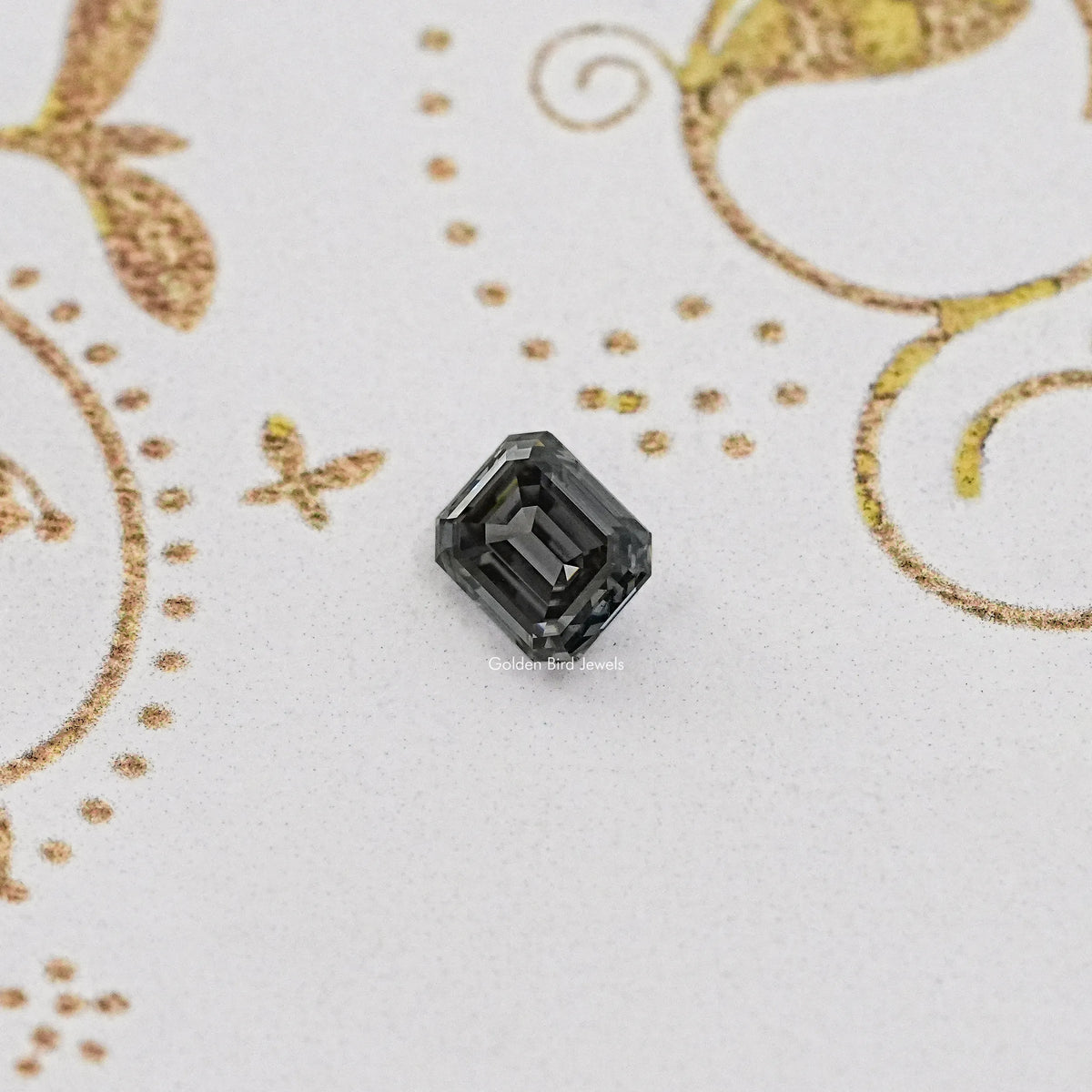 Gray emerald-cut loose gemstone, dark faceted stone centered