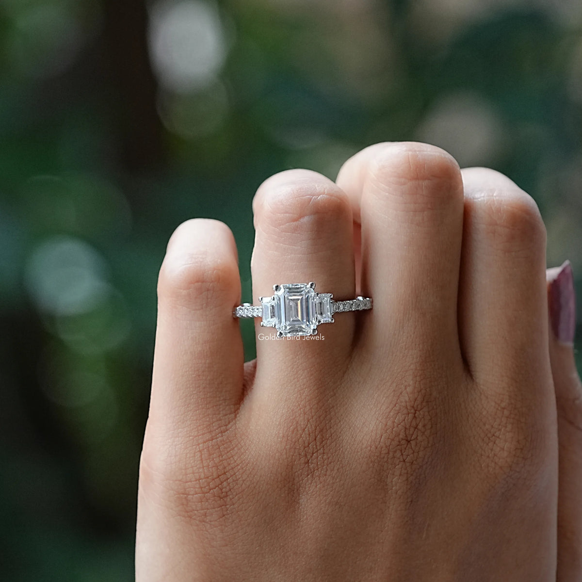 View of Emerald Cut Three Stone Moissanite Ring In Finger