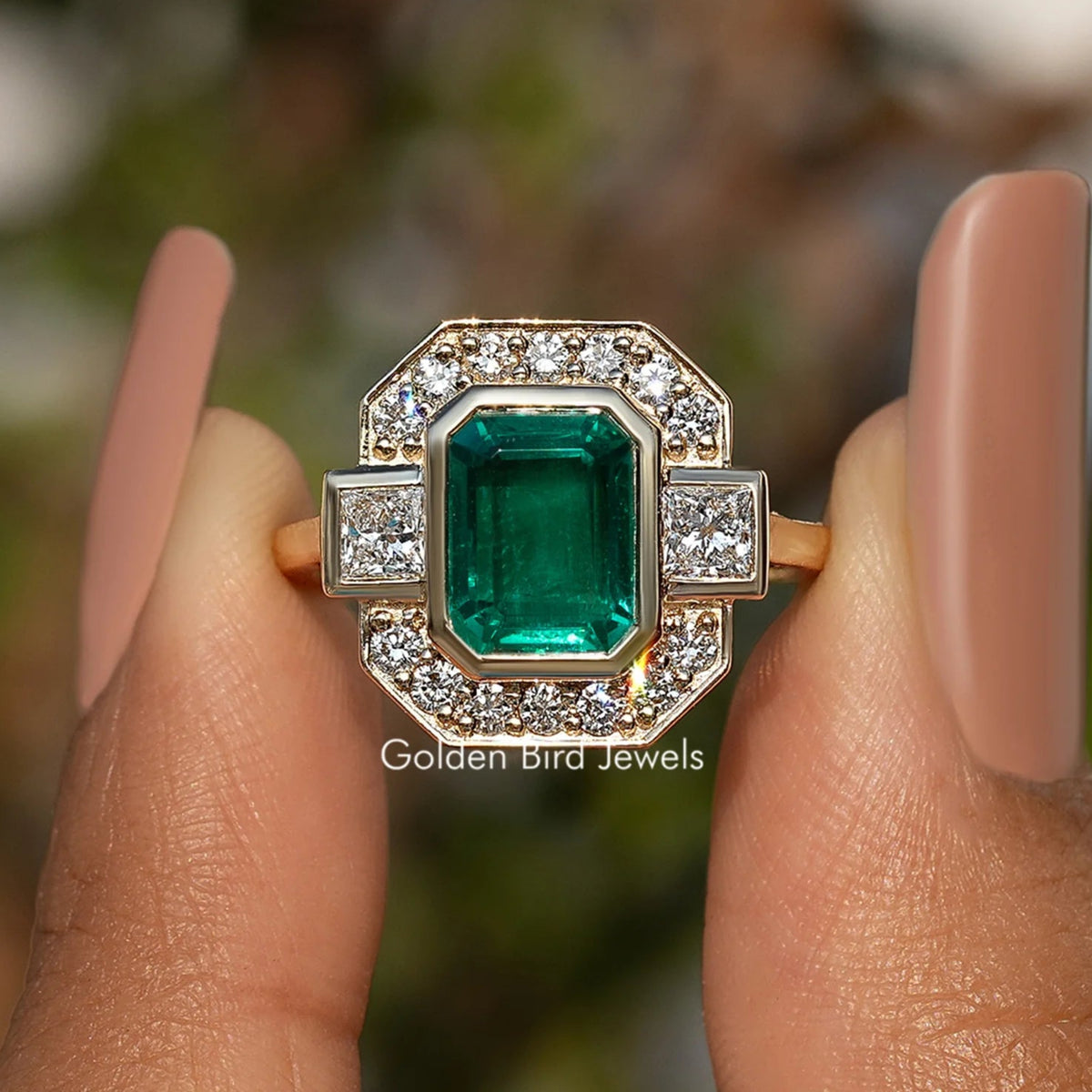 Gold-tone emerald-cut halo engagement ring with green center and clear side stones