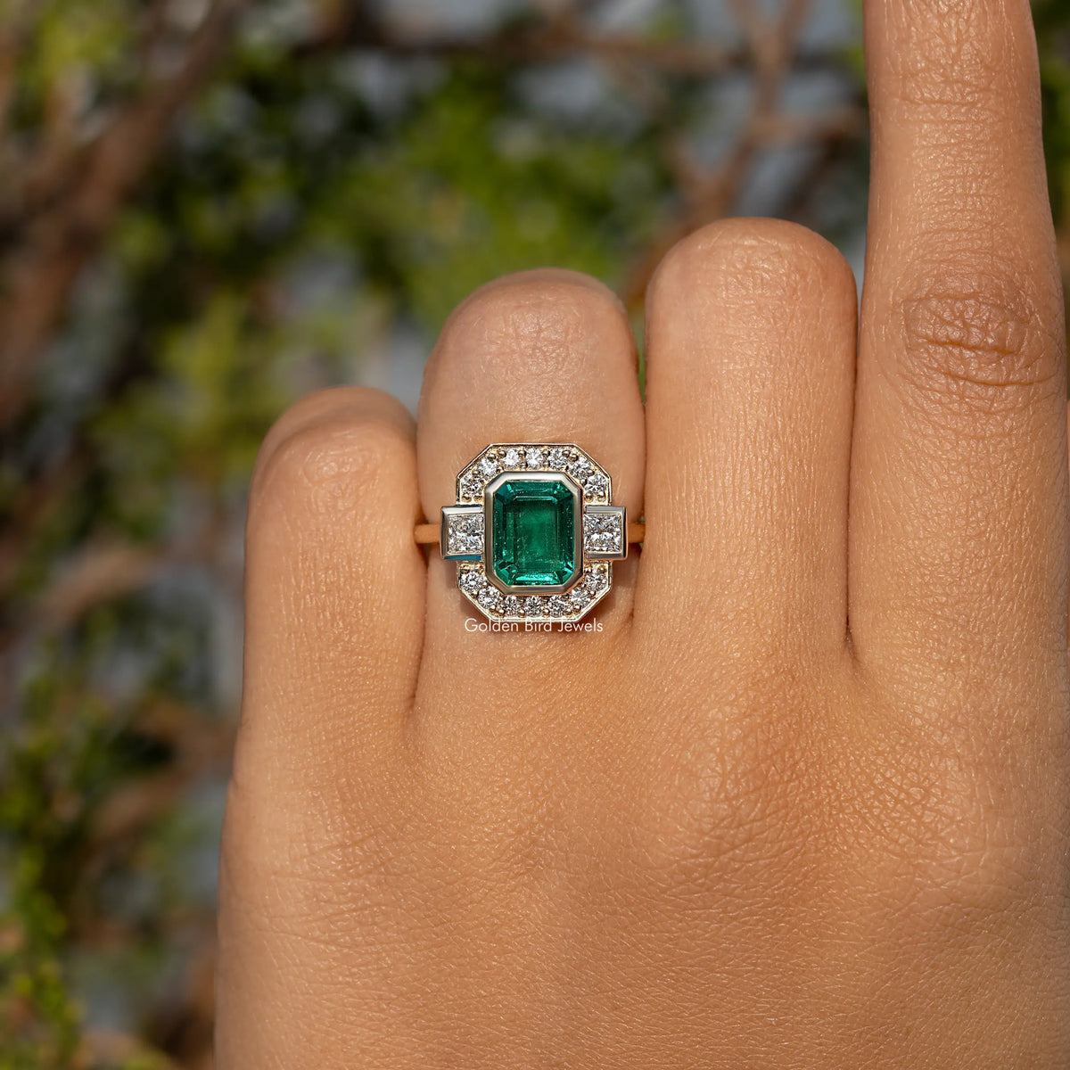Gold-tone emerald-green square center halo ring with small clear side stones
