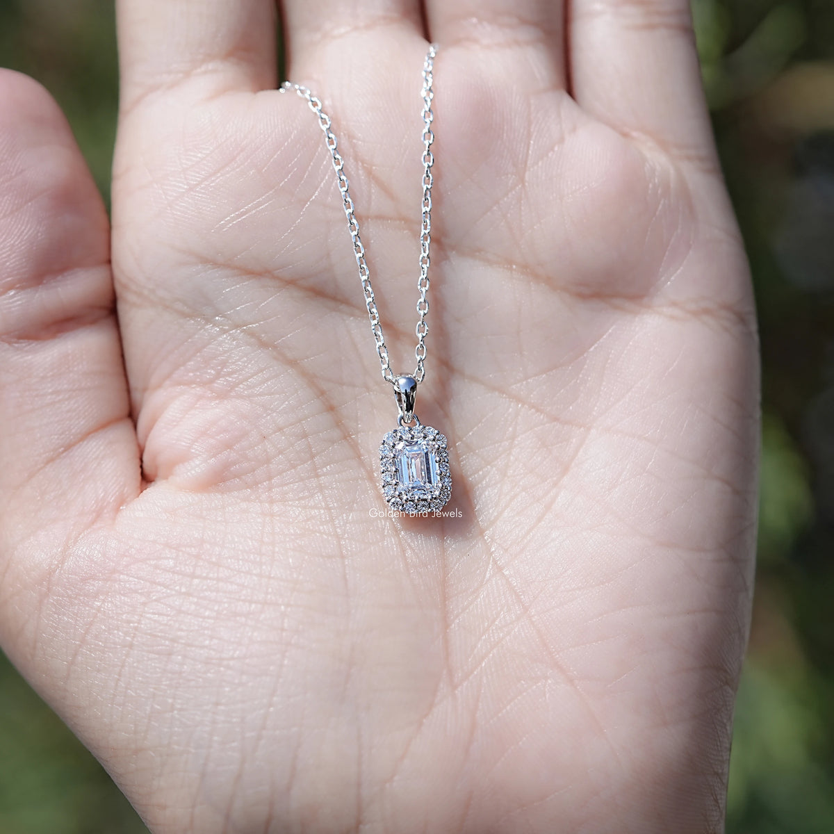 In Hand Showing of Lab Grown Emerald Cut Diamond Halo Necklace