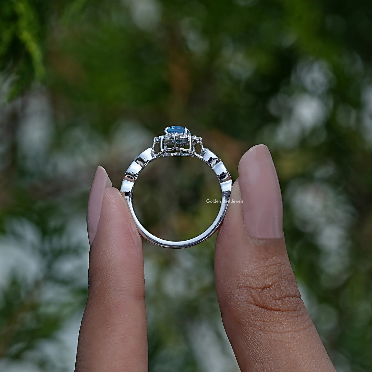 Back View of Emerald Cut Engagement Halo Ring In two fingers