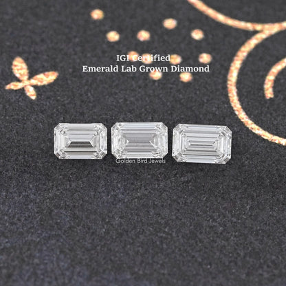 Three emerald-cut lab-grown diamond stones, clear, arranged side by side.