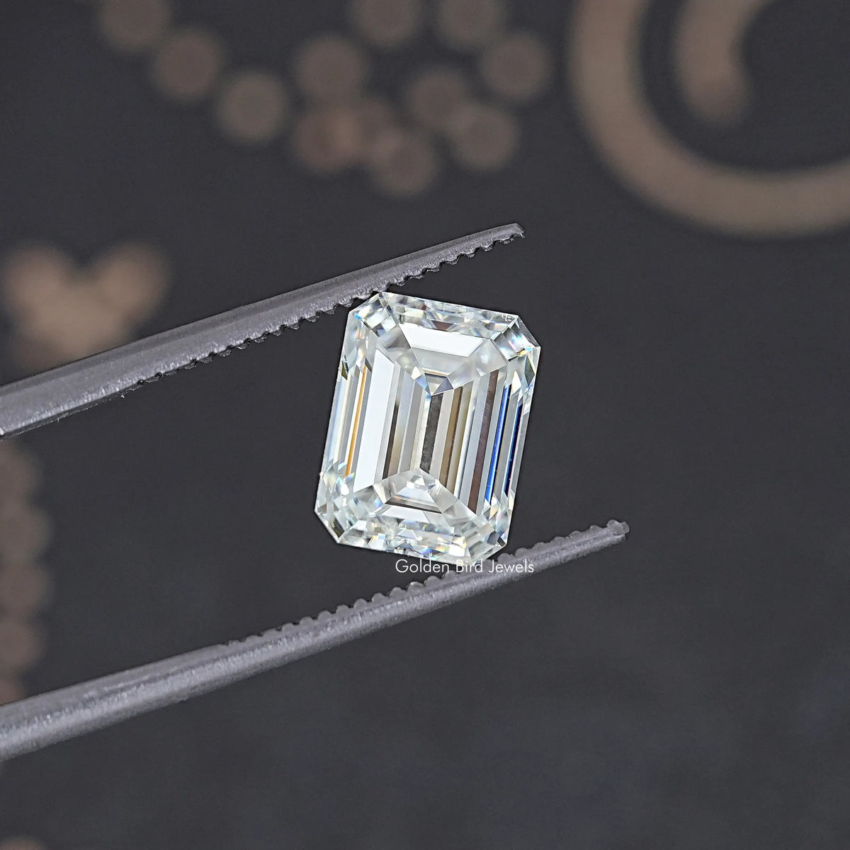 Loose emerald-cut moissanite stone, clear with crisp step facets