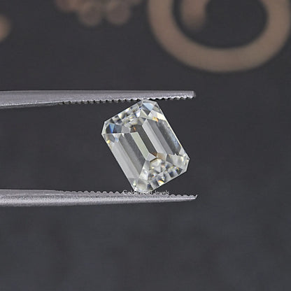 Loose emerald-cut moissanite stone shown from a slight side angle, clear