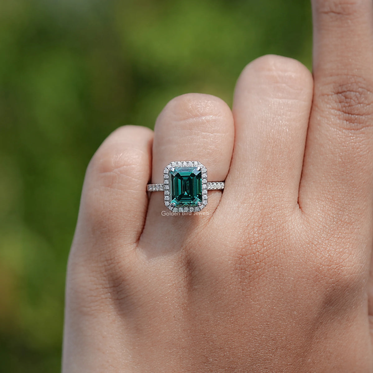Emerald-cut green moissanite ring with baguette side stones, sterling silver