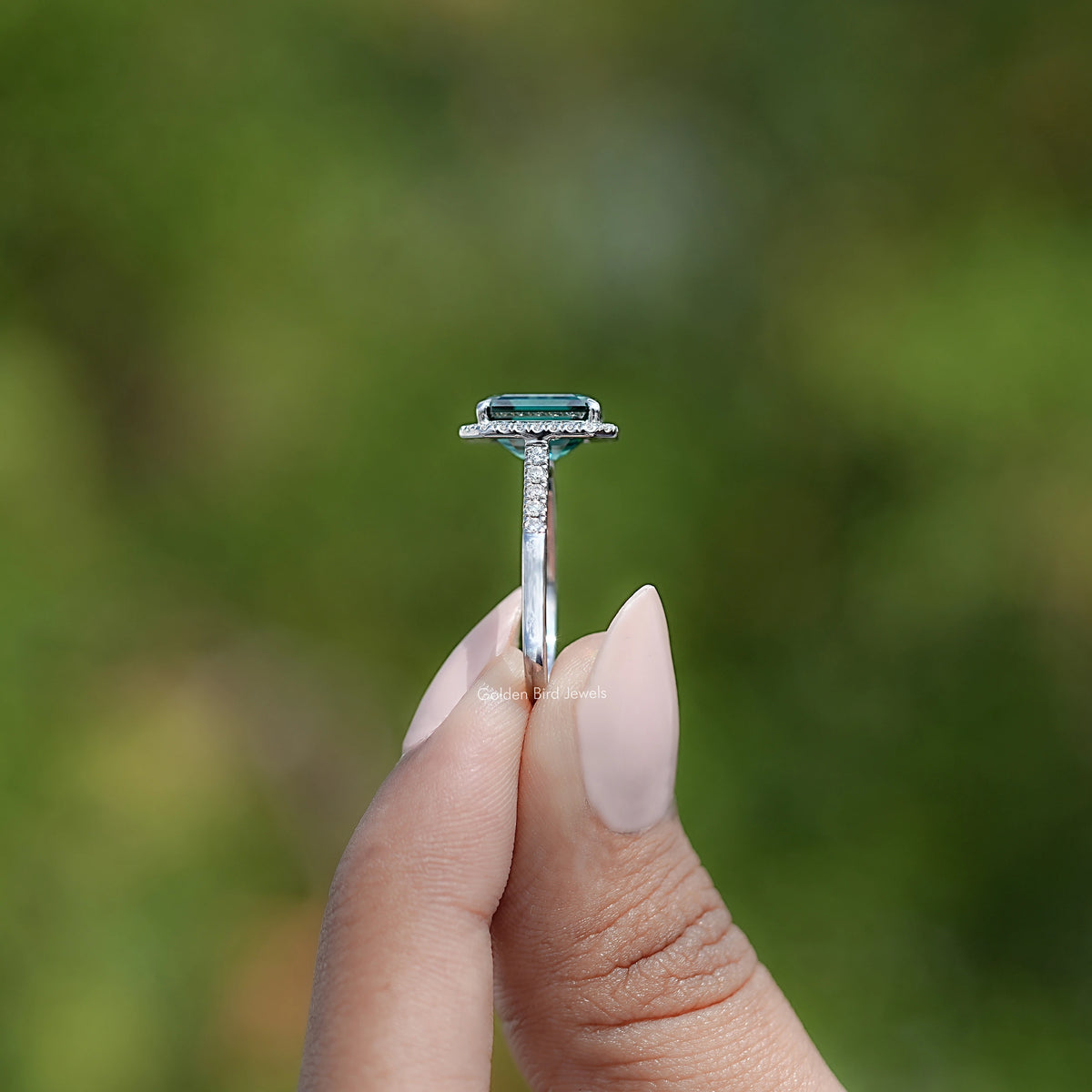 Sterling silver ring with emerald-cut center, top view with prongs