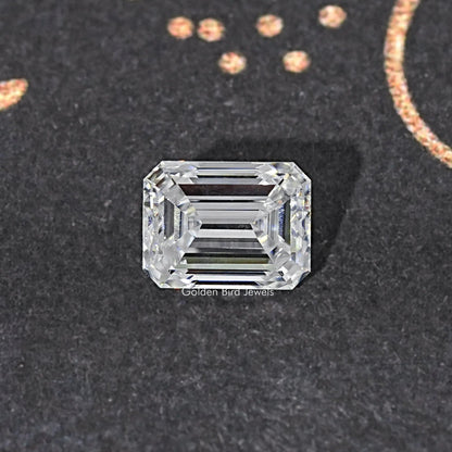 Loose emerald-cut moissanite stone, clear with centered step facets