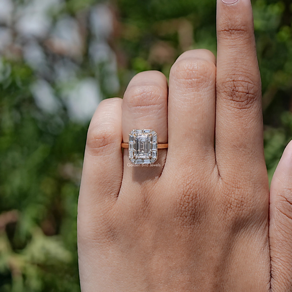 In finger view of Emerald Shaped Solitaire Moissanite Ring
