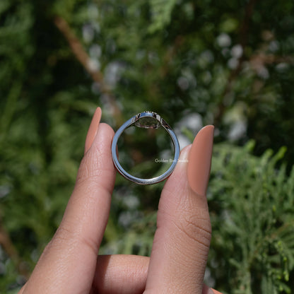 Silver-tone oval ring underside view, prongs and open bezel visible