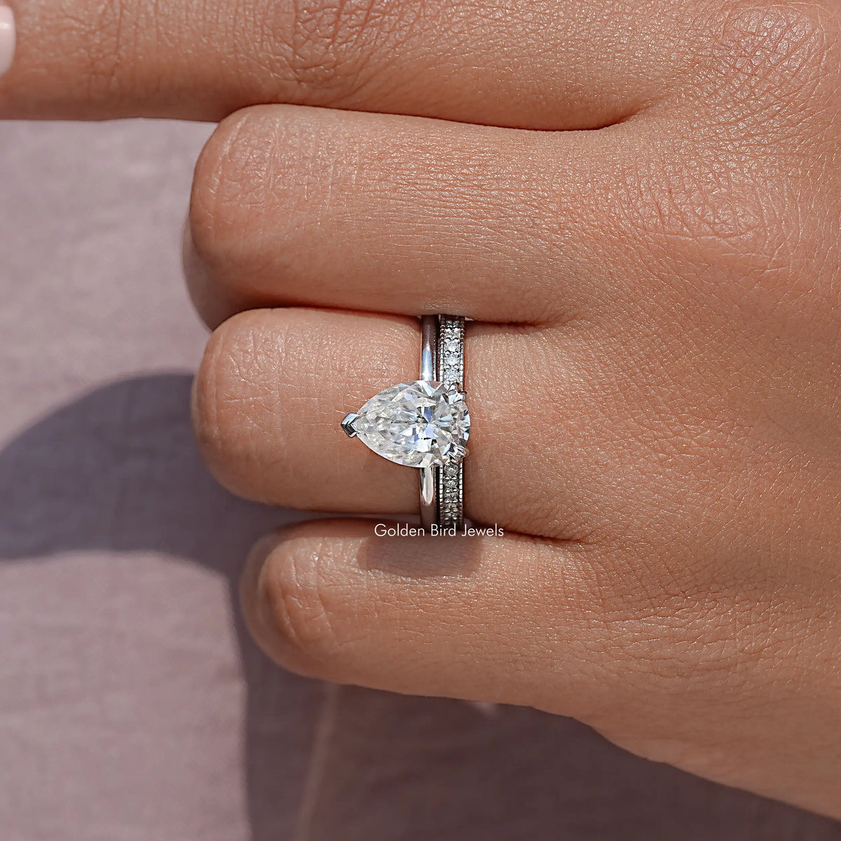 Pear moissanite ring with pavé eternity band