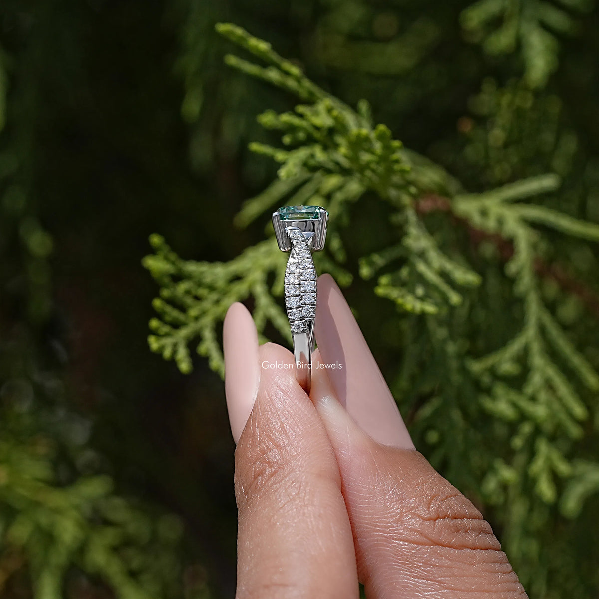 Moissanite engagement ring profile with blue cushion center and twisted split shank