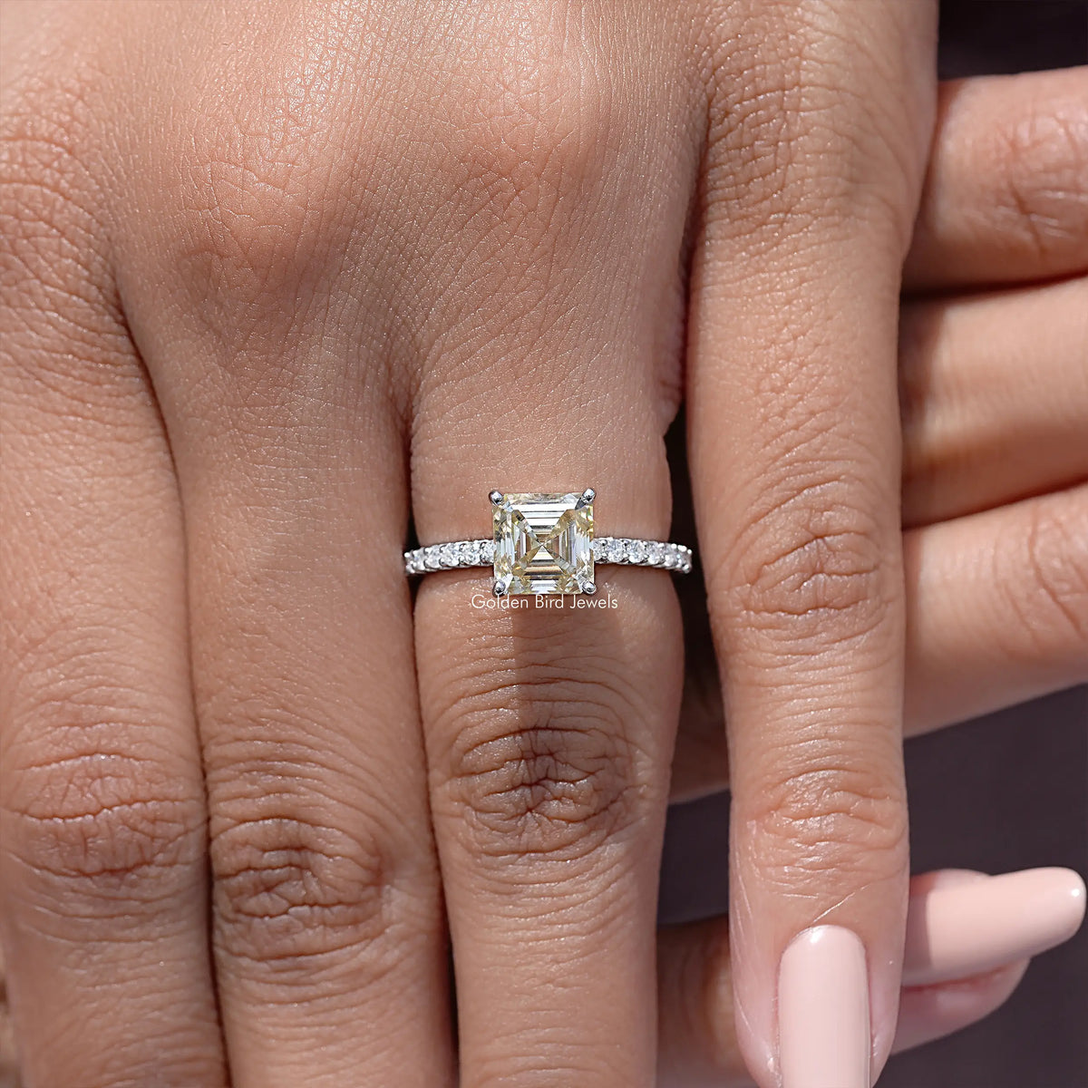 Asscher cut moissanite ring with yellow center stone and pavé silver band