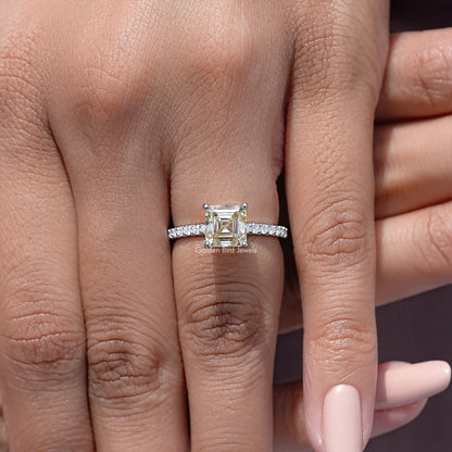 Asscher cut moissanite ring with yellow center stone and pavé silver band