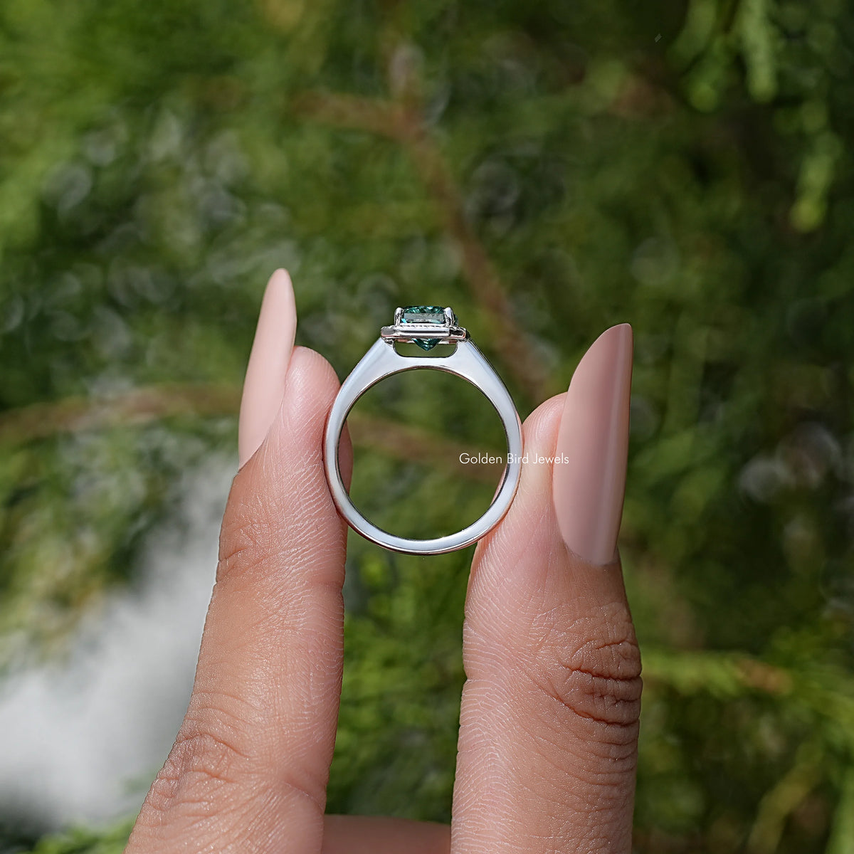 Sterling silver open view ring with emerald-cut blue moissanite halo