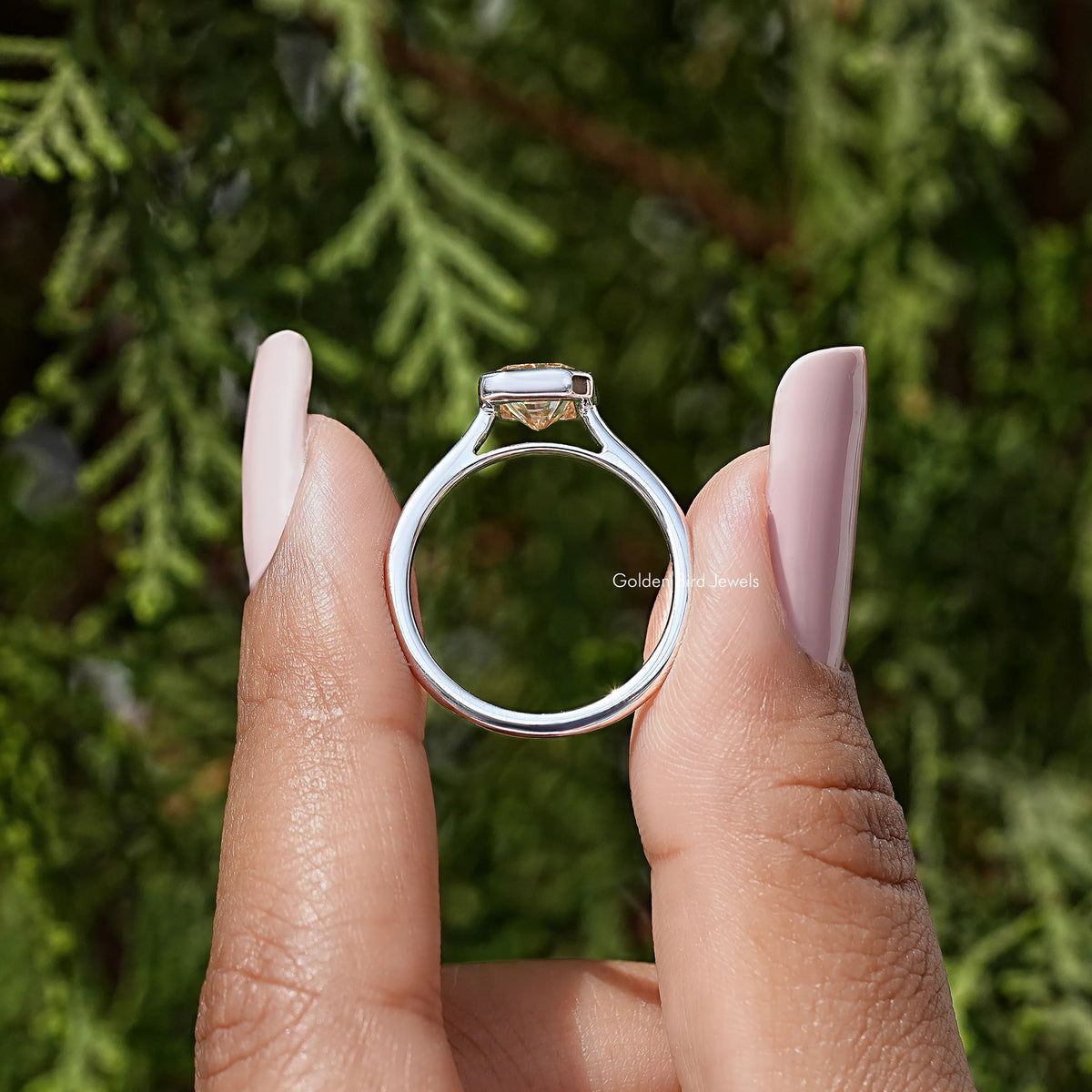 Radiant-cut solitaire ring back view, rose-gold band with bezel-set square stone
