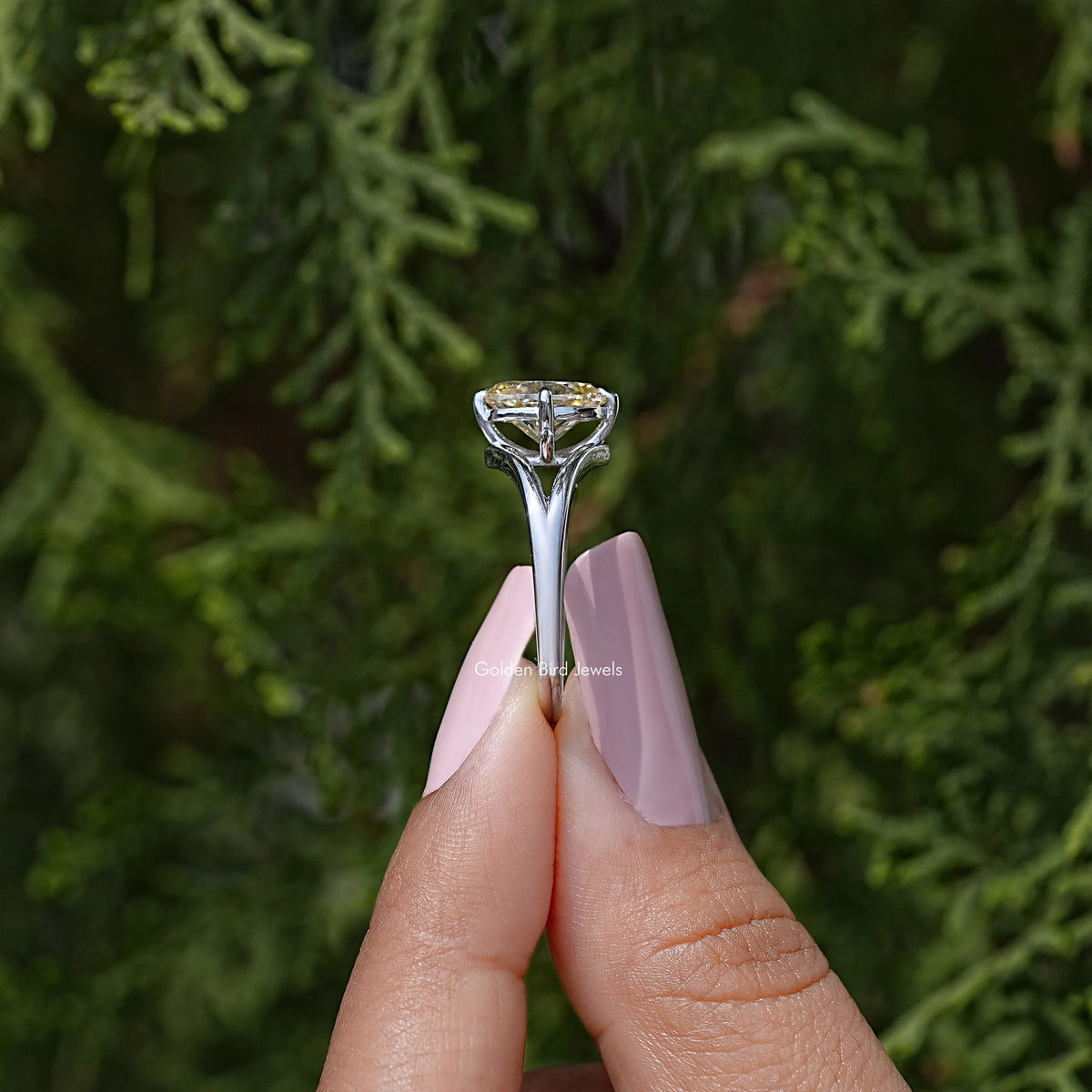 Oval moissanite split-shank engagement ring with prong-set center stone, top view