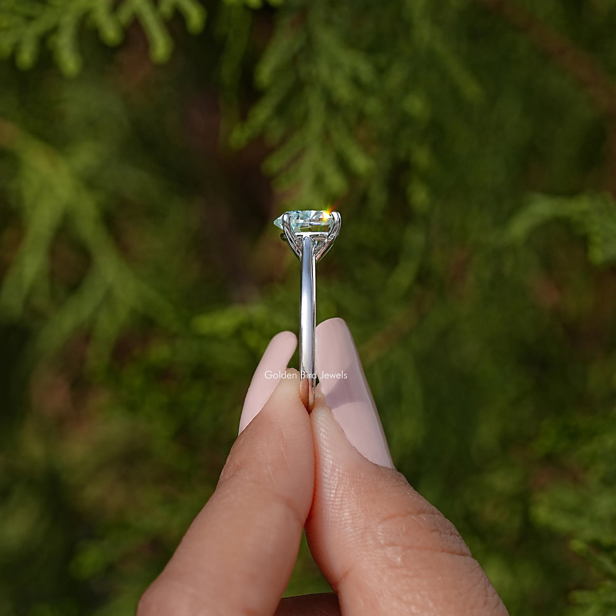 Solitaire ring showing gemstone top view with prongs, sterling silver band