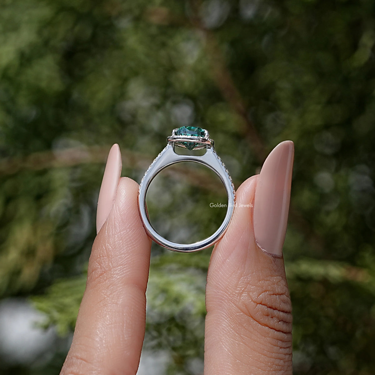 Sterling silver ring side profile with green pear moissanite center and halo setting