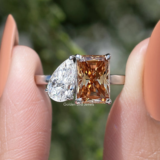 Toi et moi ring close-up with pear white moissanite and square warm brown center