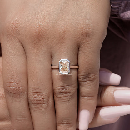 Radiant-cut solitaire ring, rose-gold band with bezel-set square stone