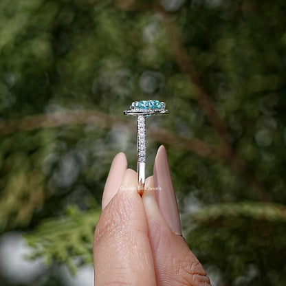 Heart-cut blue accent sterling silver wedding ring, side view on a finger