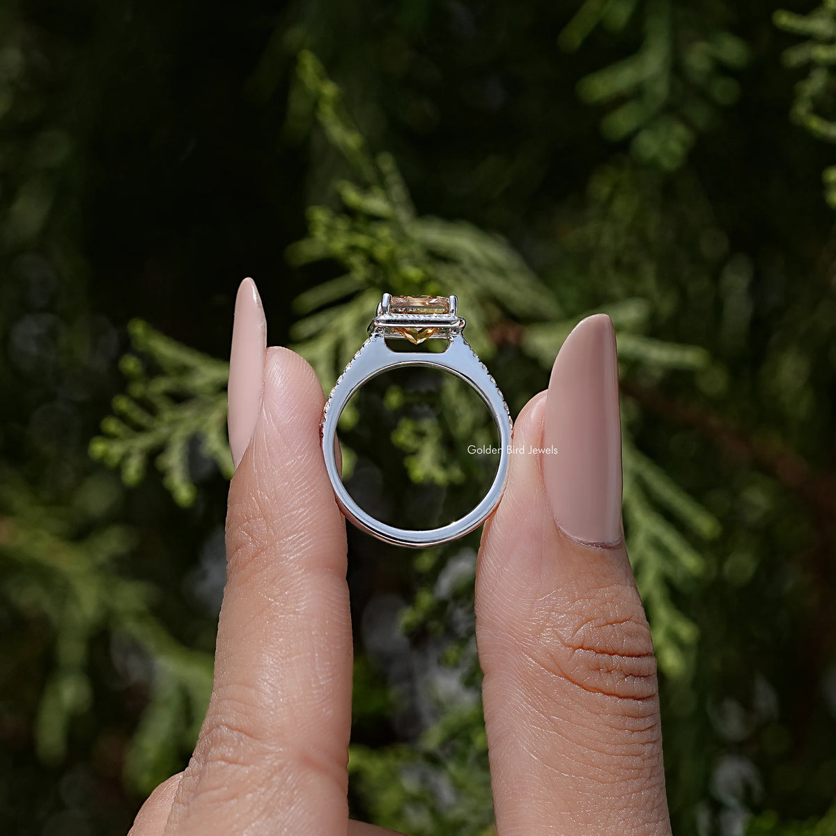 Sterling silver moissanite halo ring shown from front with prong-set center