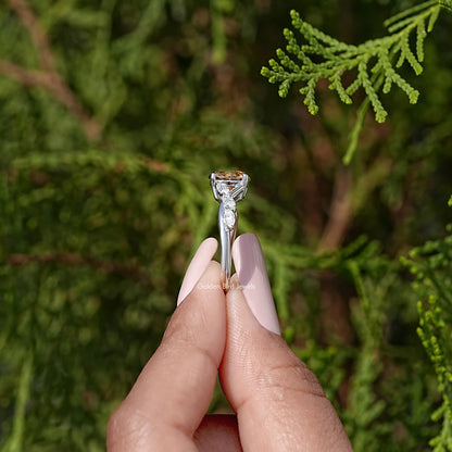 Side view of sterling silver ring with round yellow moissanite and prong settings