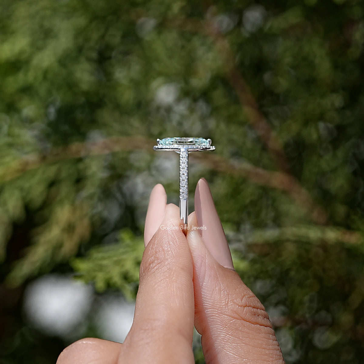 Sterling silver vertical prong bridal ring with marquise-cut blue stone