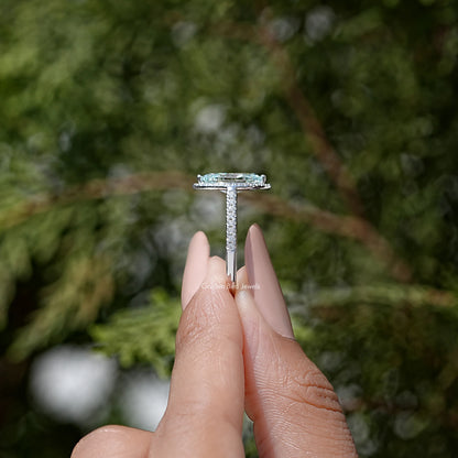 Sterling silver vertical prong bridal ring with marquise-cut blue stone
