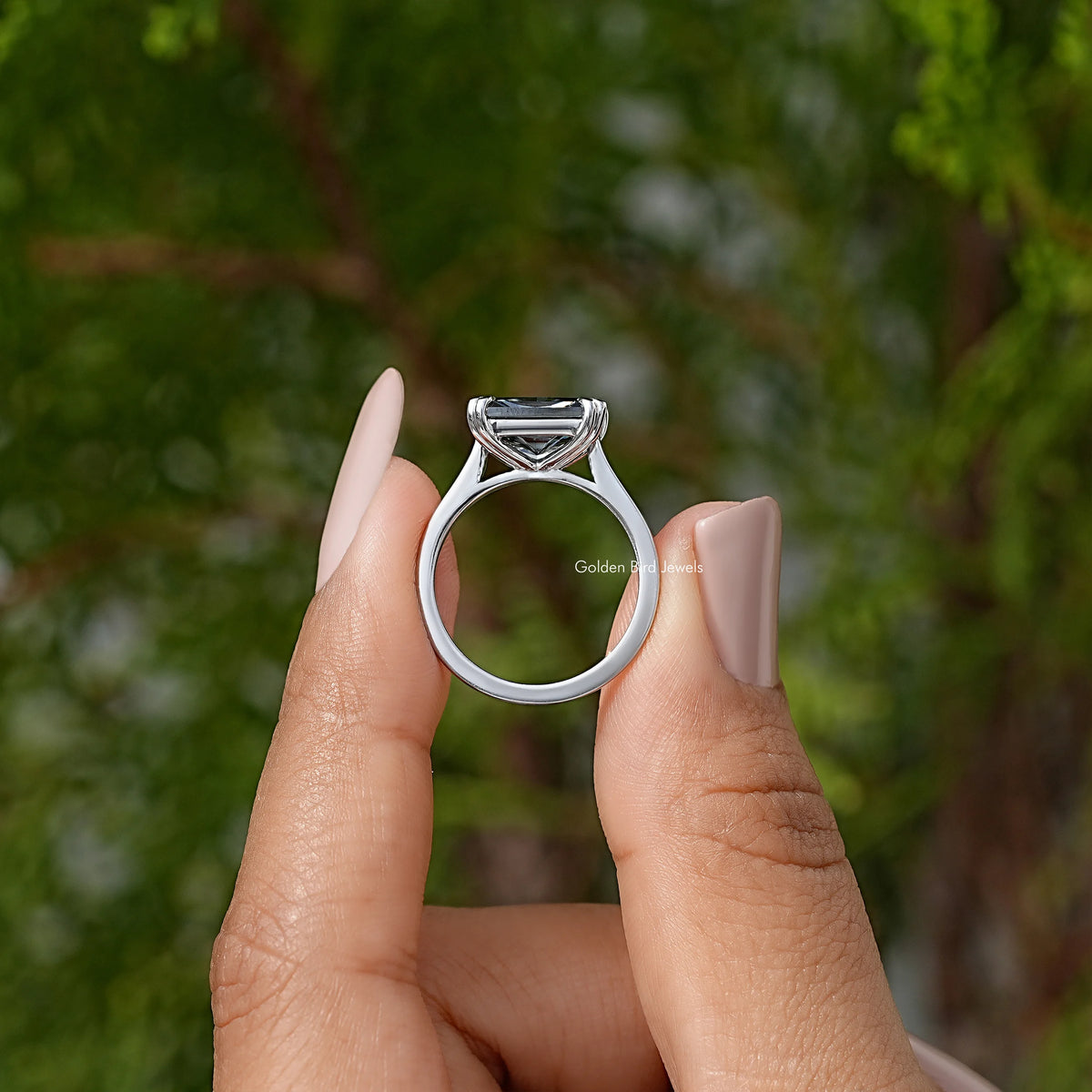 Silver solitaire engagement ring with square black gemstone, top view